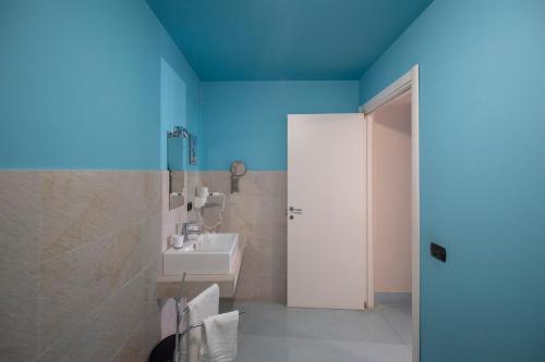 a bathroom with a sink and a blue ceiling at Tenuta Santa Tecla in Acireale
