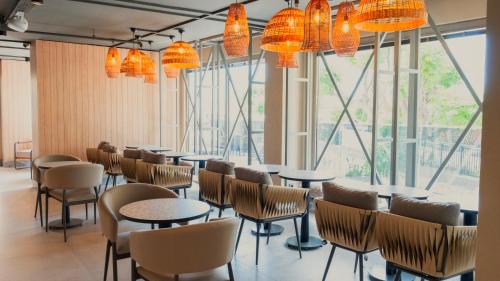 a row of tables and chairs in a room with large windows at Kleopatra Dreams Beach Hotel in Alanya