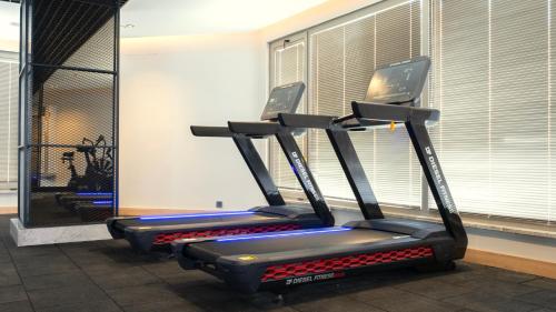 a gym with two tread machines in a room at Kleopatra Dreams Beach Hotel in Alanya