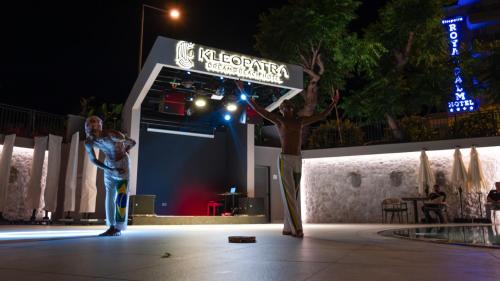 a man standing on a stage at night at Kleopatra Dreams Beach Hotel in Alanya