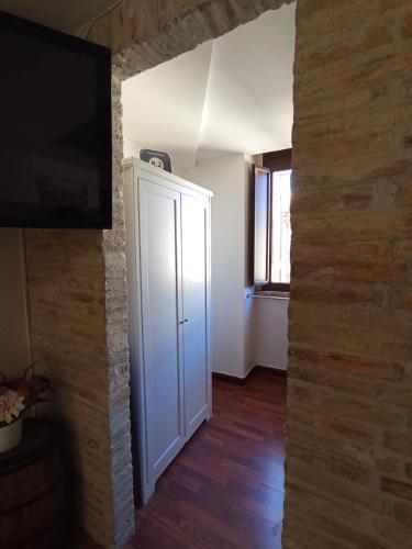 a room with a white door and a brick wall at Casa Paradiso in Chieti