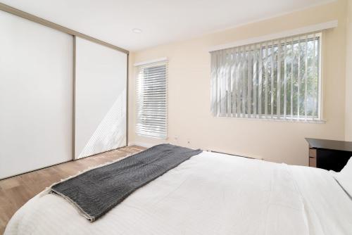 a bedroom with a large white bed and a window at Bright, Newly Remodeled 1BR in PA Second Downtown in Palo Alto