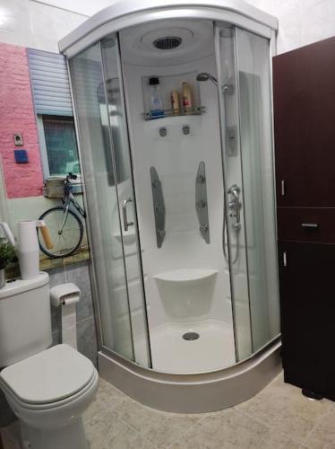 a bathroom with a shower with a toilet and a bike at Casa Capi in La Orotava