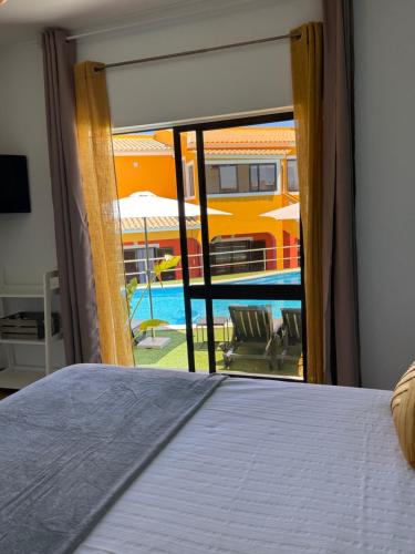 a bedroom with a bed and a view of a pool at Casa Concha - Peaceful and Relaxing in Lagos