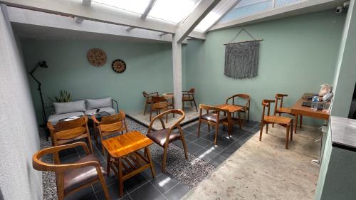 a room with a table and chairs and a dining room at FX Stay & Coffee in Yogyakarta