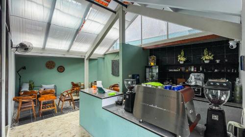 a kitchen with a counter and a dining room at FX Stay & Coffee in Yogyakarta