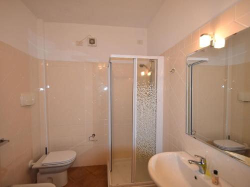 a bathroom with a shower and a toilet and a sink at Apartment by Lake Maggiore with Stunning View in Oggebbio