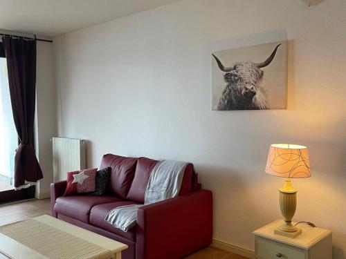 a living room with a couch and a picture of a bull at Apartment by Lake Maggiore with Stunning View in Oggebbio
