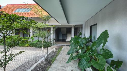 an external view of a house with plants in front of it at FX Stay & Coffee in Yogyakarta