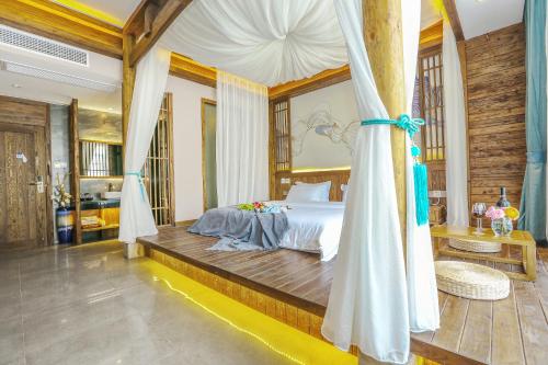 a bedroom with a bed with a canopy at Pure House in Zhangjiajie