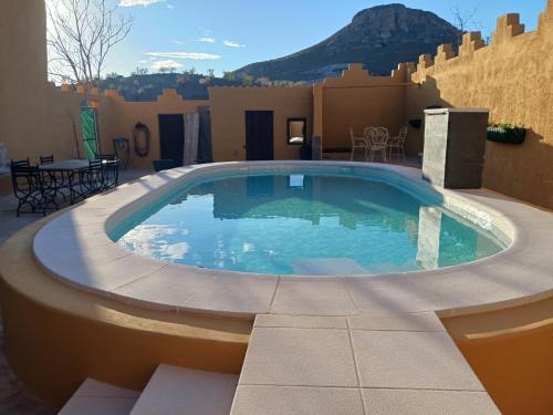 a swimming pool in the middle of a patio at Casa rural los Cerezos in Albox