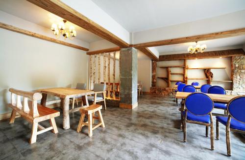 a dining room with blue chairs and a table at Pure House in Zhangjiajie