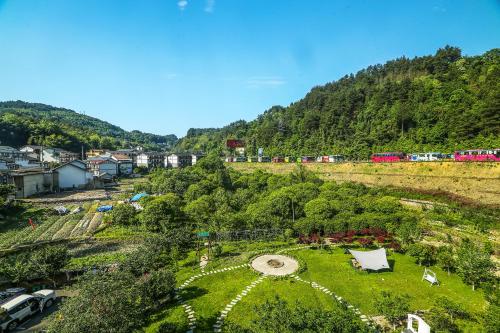 a park on a hill with a train in the background at Pure House in Zhangjiajie