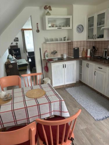 a kitchen with a table and chairs in a room at Vila Kysuca in Luhačovice