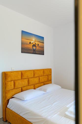 a bedroom with a bed with white sheets at Vila Dura in Ksamil