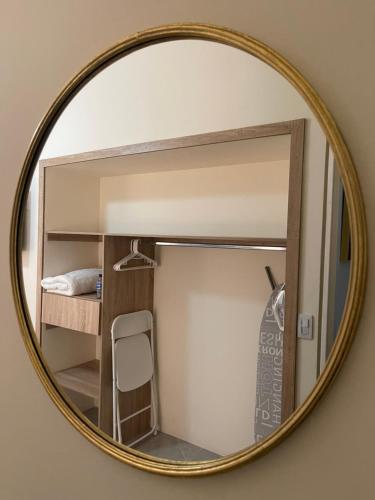 a mirror reflecting a bedroom with a bunk bed at Cal Bed & Breakfast Ibague in Ibagué