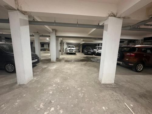 an empty parking garage with cars parked in it at MPS Sai Palace in Tiruvannāmalai