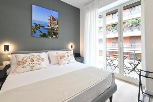 a bedroom with a bed and a large window at Ponte di Tappia Suites in Naples