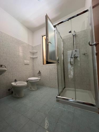 a bathroom with a shower and a toilet and a sink at Villetta Mara. A due passi da Gallipoli. in Marina di Mancaversa