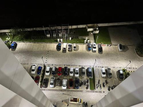 an overhead view of a parking lot with cars parked at San Service Apartment by Dolfy in Kelambākkam