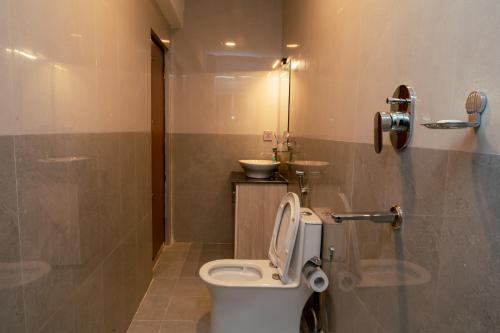 a bathroom with a toilet and a sink at Pine Tree Resort in Nagarkot