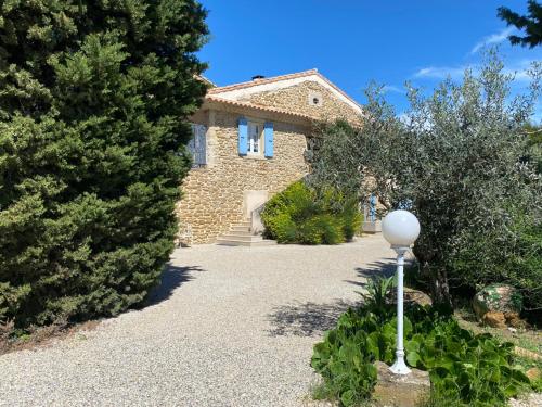 a stone house with a street light in front of it at LA MAGNANERIE in Grillon
