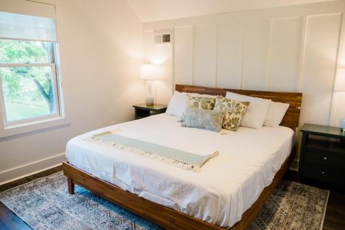a bedroom with a large bed with a window at Kaya Cottages in Dahlonega