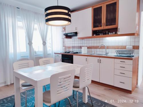 a kitchen with a white table and white chairs at Lumani Apartment Zagreb with FREE Parking in Zagreb