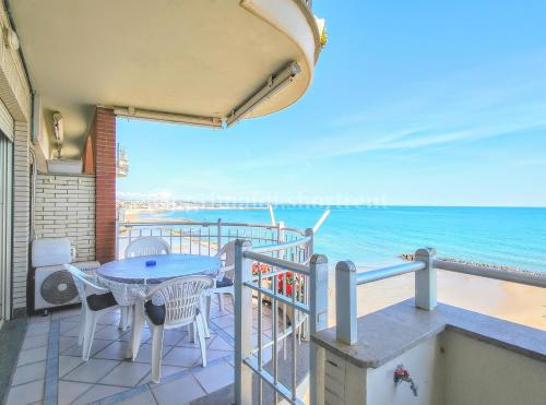 a balcony with a table and chairs and the ocean at Colibrì in Nettuno