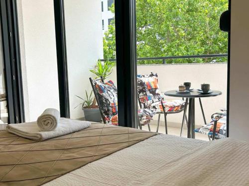 a bed in a bedroom with a view of a balcony at LanaMarija Apartment in Trebinje