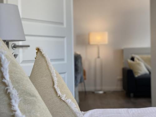 a view of a bedroom with a bed and a living room at Villa Rosalie Sassnitz in Sassnitz