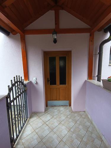 a entrance to a house with a wooden door at Apartman EMA in Kulen Vakuf