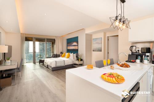 a kitchen and living room with a bed in a room at Fashion avenue Dubai Mall -The Residence in Dubai