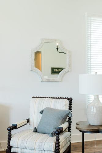 a mirror above a chair in a living room at Kaya Cottages in Dahlonega