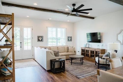 a living room with a couch and a ceiling fan at Kaya Cottages in Dahlonega