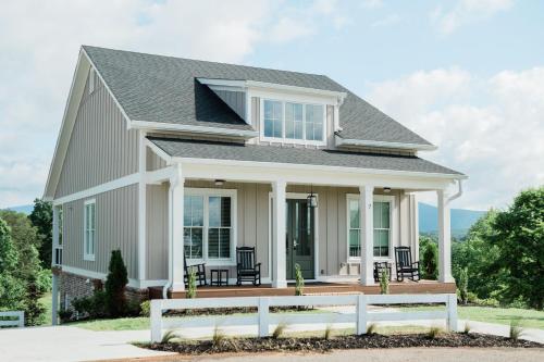 a house with a porch with chairs on it at Kaya Cottages in Dahlonega