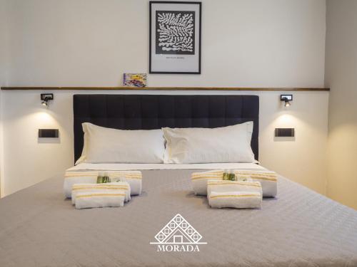 1 dormitorio con 1 cama grande y 4 almohadas en Casa PiMa - MORADA, en Iglesias