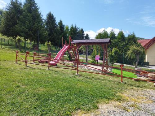 a playground with a slide in a field at Pod Bercem in Solina