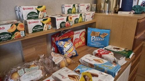a shelf filled with bags of food and snacks at Casa di Igor in Casemurate