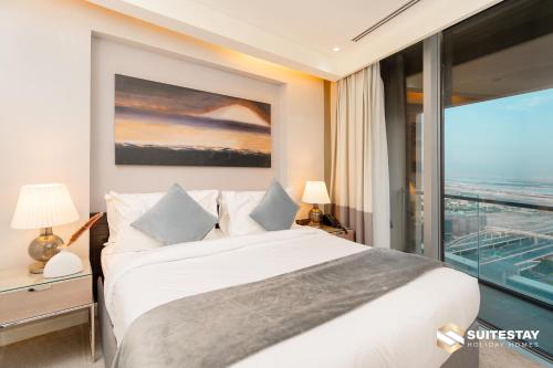 a bedroom with a bed and a large window at Fashion avenue Dubai Mall -The Residence in Dubai