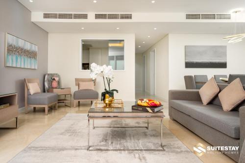 a living room with a couch and a table at Fashion avenue Dubai Mall -The Residence in Dubai