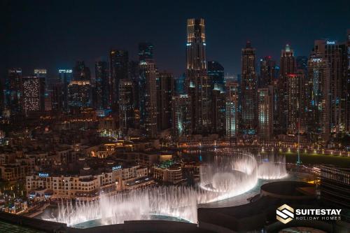 a view of a city at night with a fountain at Fashion avenue Dubai Mall -The Residence in Dubai