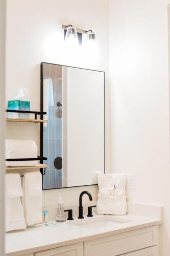 a bathroom with a sink and a mirror at Kaya Cottages in Dahlonega