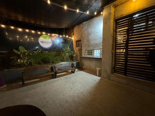 a dark room with a bench and a sign on the wall at Viewleaf Resort Hotel in Marikina