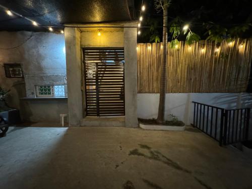 a room with a door and a fence at night at Viewleaf Resort Hotel in Marikina