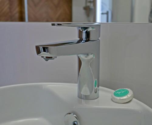 a bathroom sink with a faucet on top of it at Alda in Pyrzowice
