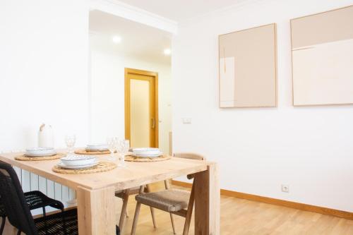 Un comedor con mesa y sillas de madera. en Progreso Sanxenxo, en Sanxenxo