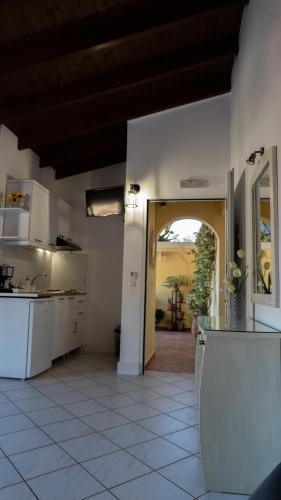 a kitchen with white appliances and a door to a yard at Studios Vaso - Center in Parga
