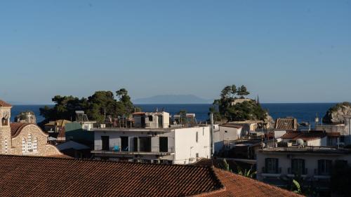 a city with roofs and the ocean in the background at Studios Vaso - Center in Parga