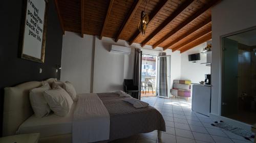 a bedroom with a bed and a living room at Studios Vaso - Center in Parga